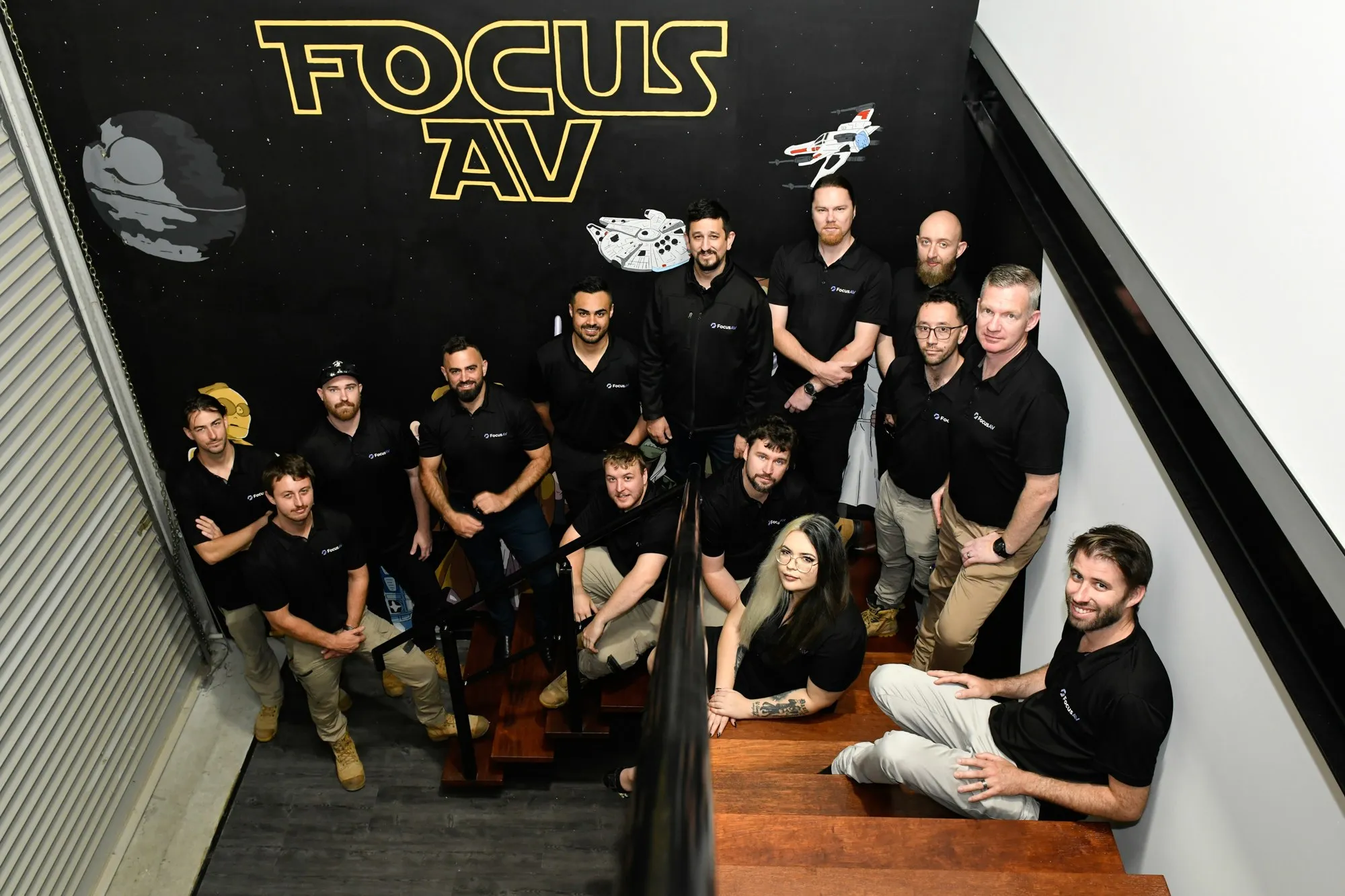 The Focus AV team gathered on the workshop stairs — the people behind the Focus Care support program