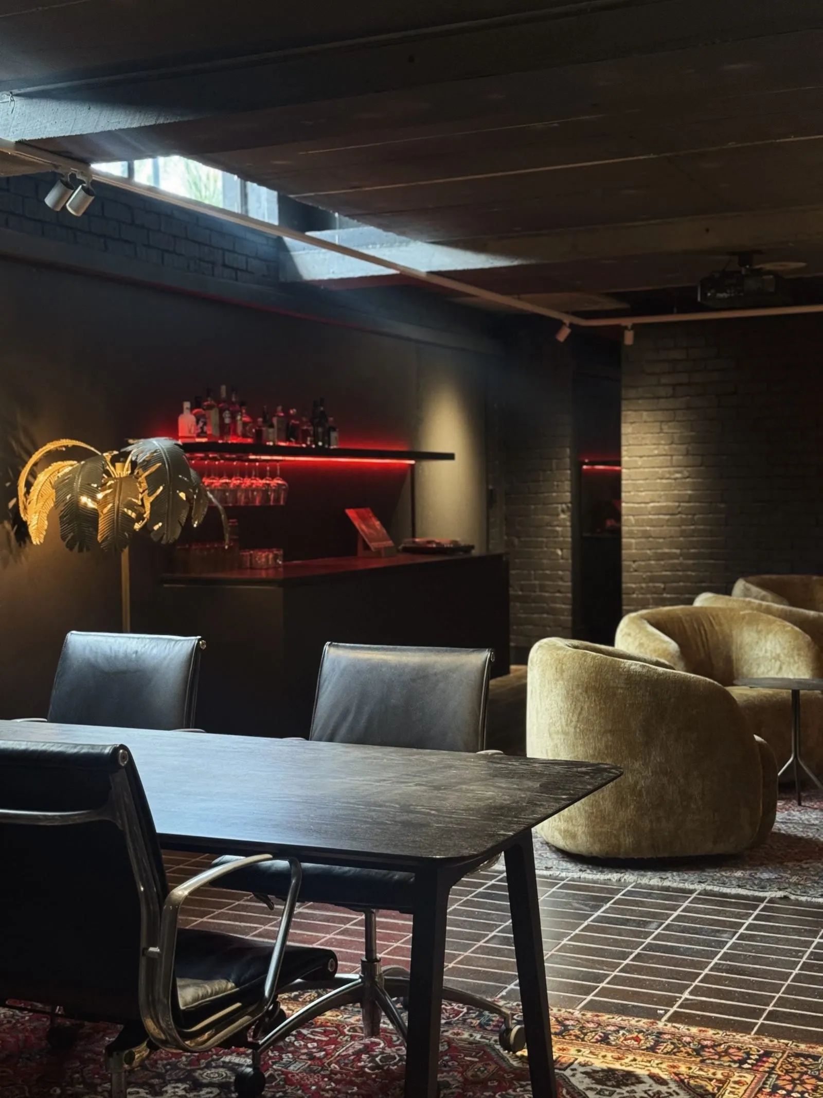 The Bunker by Robeson Architects — a design-led Perth fit-out of dark brick, timber and soft furnishings with the AV concealed in the architecture