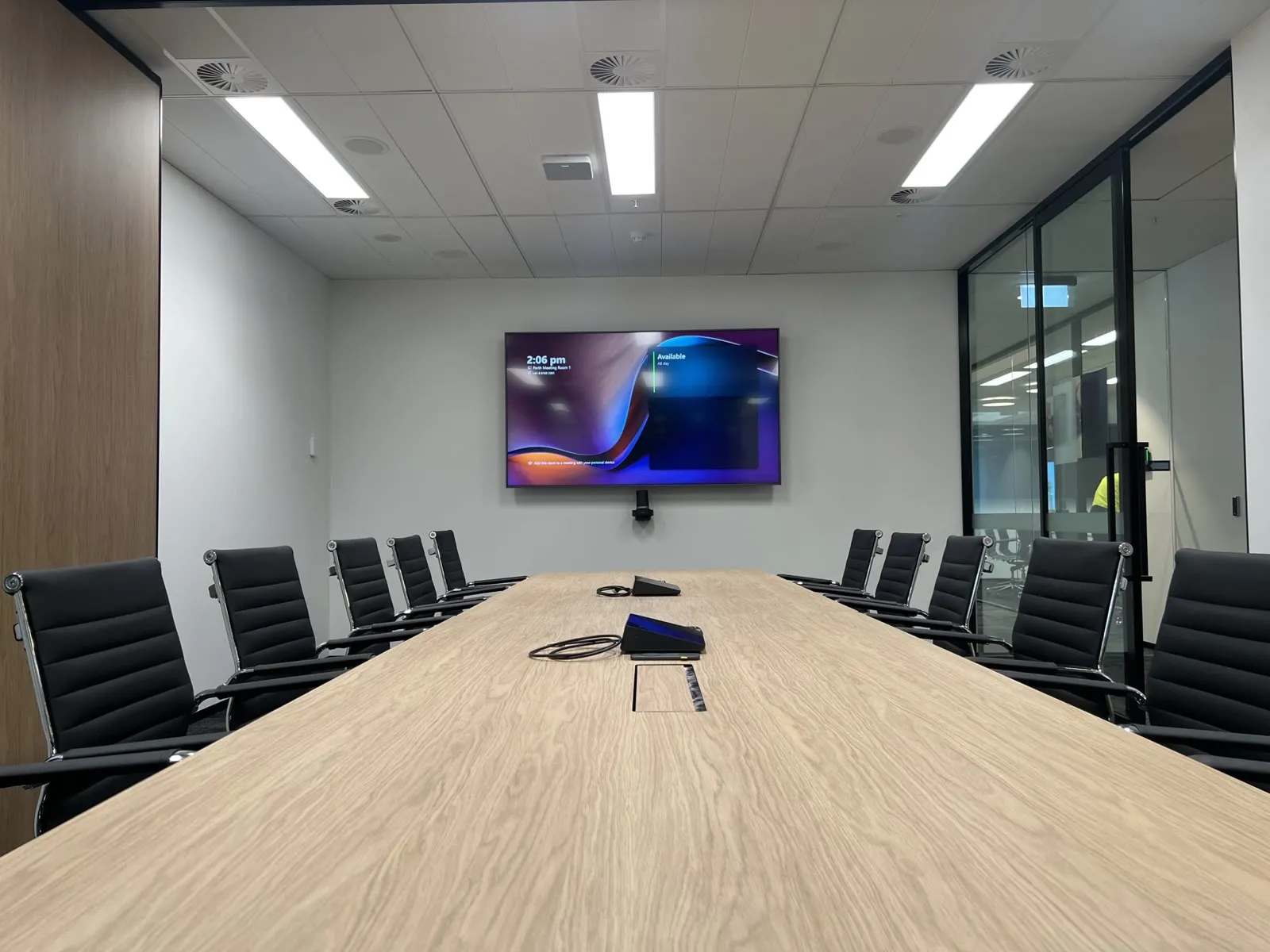 A Linkforce meeting room in Perth where the wall-mounted commercial display runs branded room content between meetings