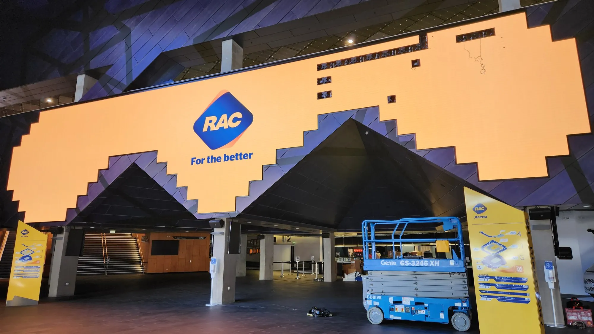 Scissor lifts working under RAC Arena's entry canopy as its LED surface goes in