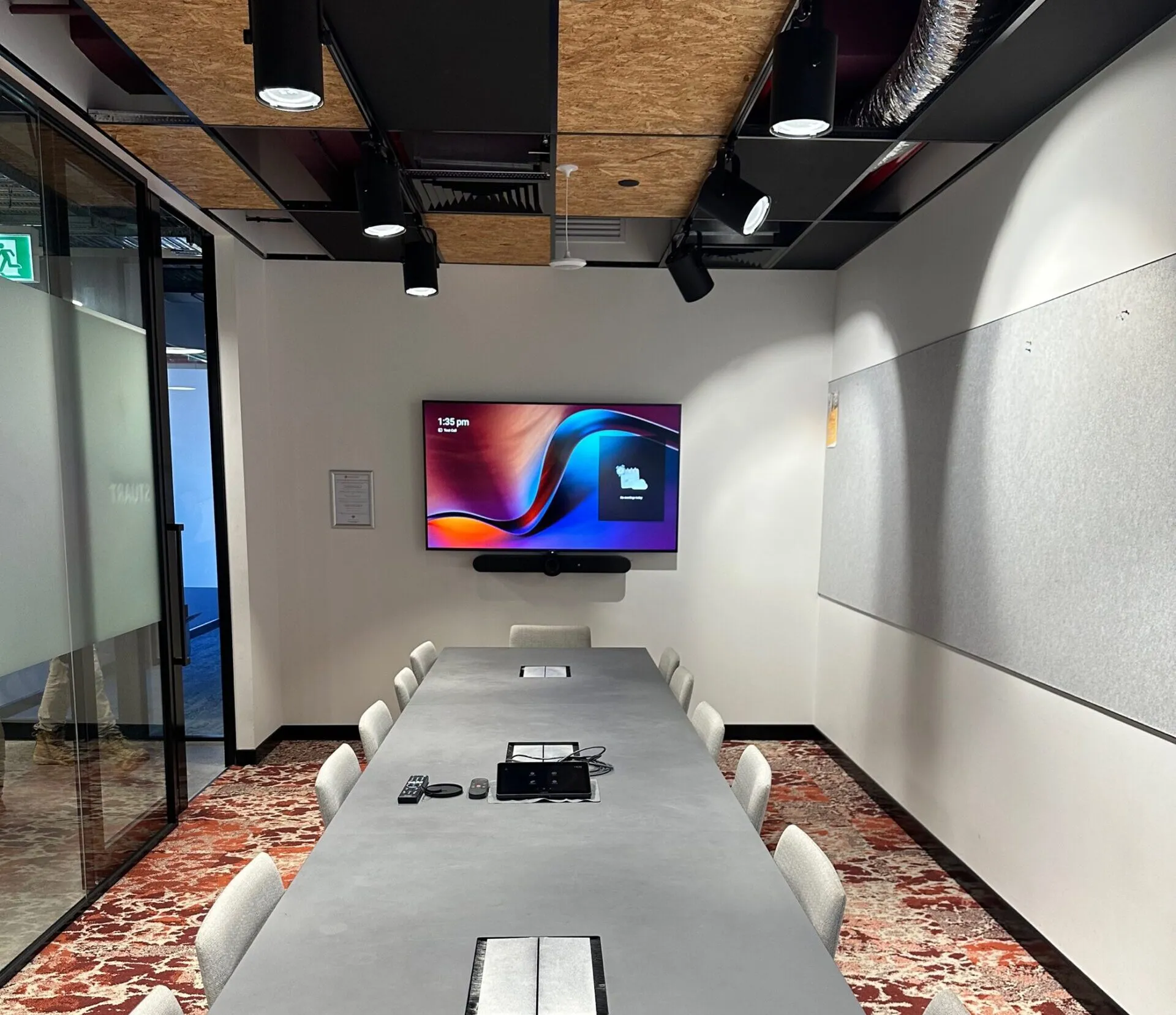 A real Focus AV Microsoft Teams Room install — display with Teams standby, Logitech video bar, touch console on the table and acoustic wall panel