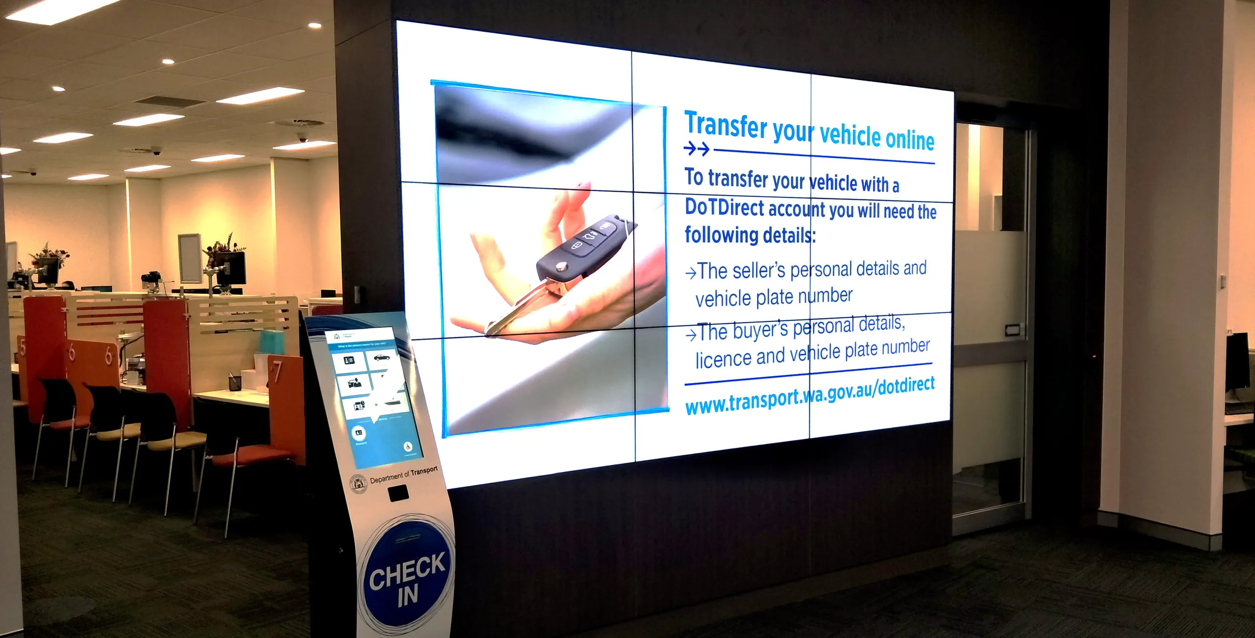 An LCD video wall in a Perth service centre, its nine panels meeting in a visible grid of bezel lines across the image