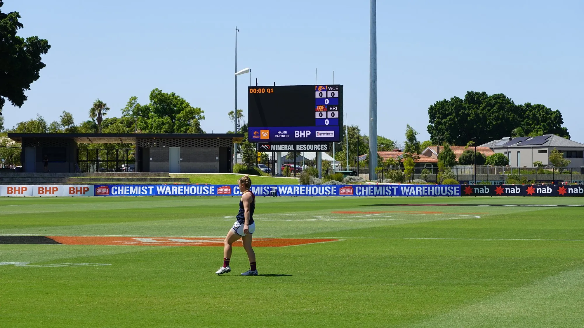 A training oval with an LED scoreboard live and sponsor ribbon boards along the boundary fence